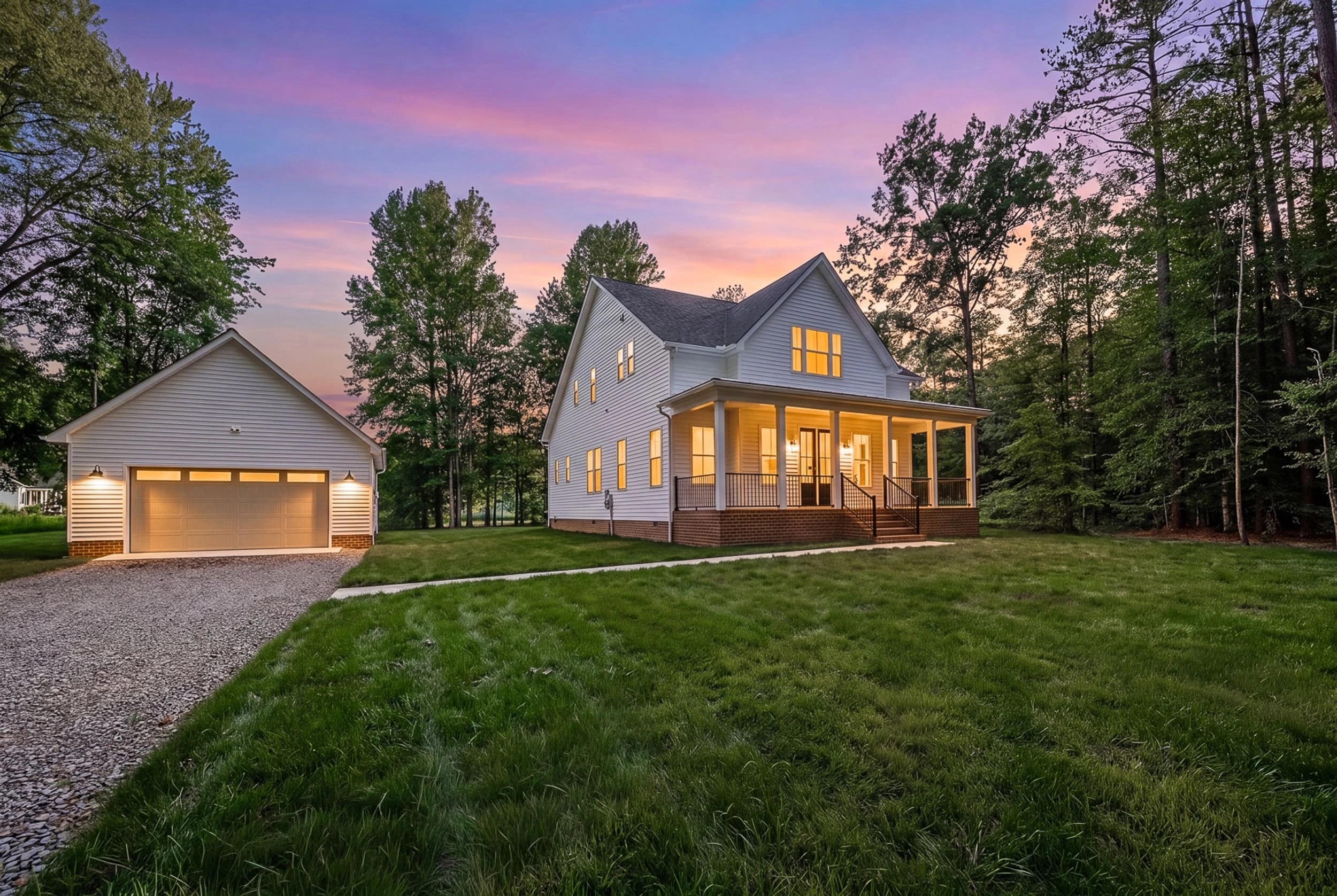 Custom farmhouse build — twilight exterior with lit windows