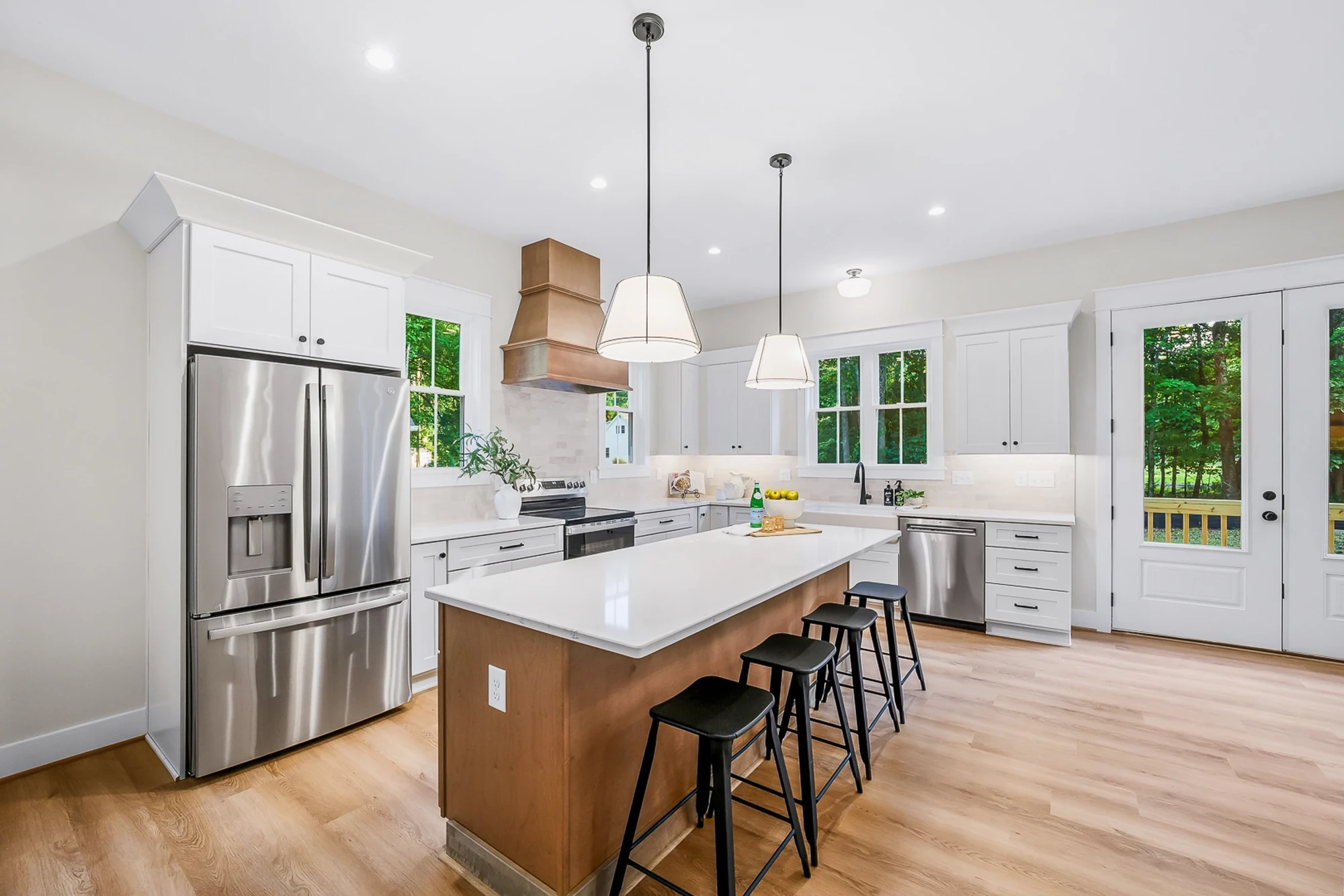 Custom kitchen — stainless appliances and copper range hood