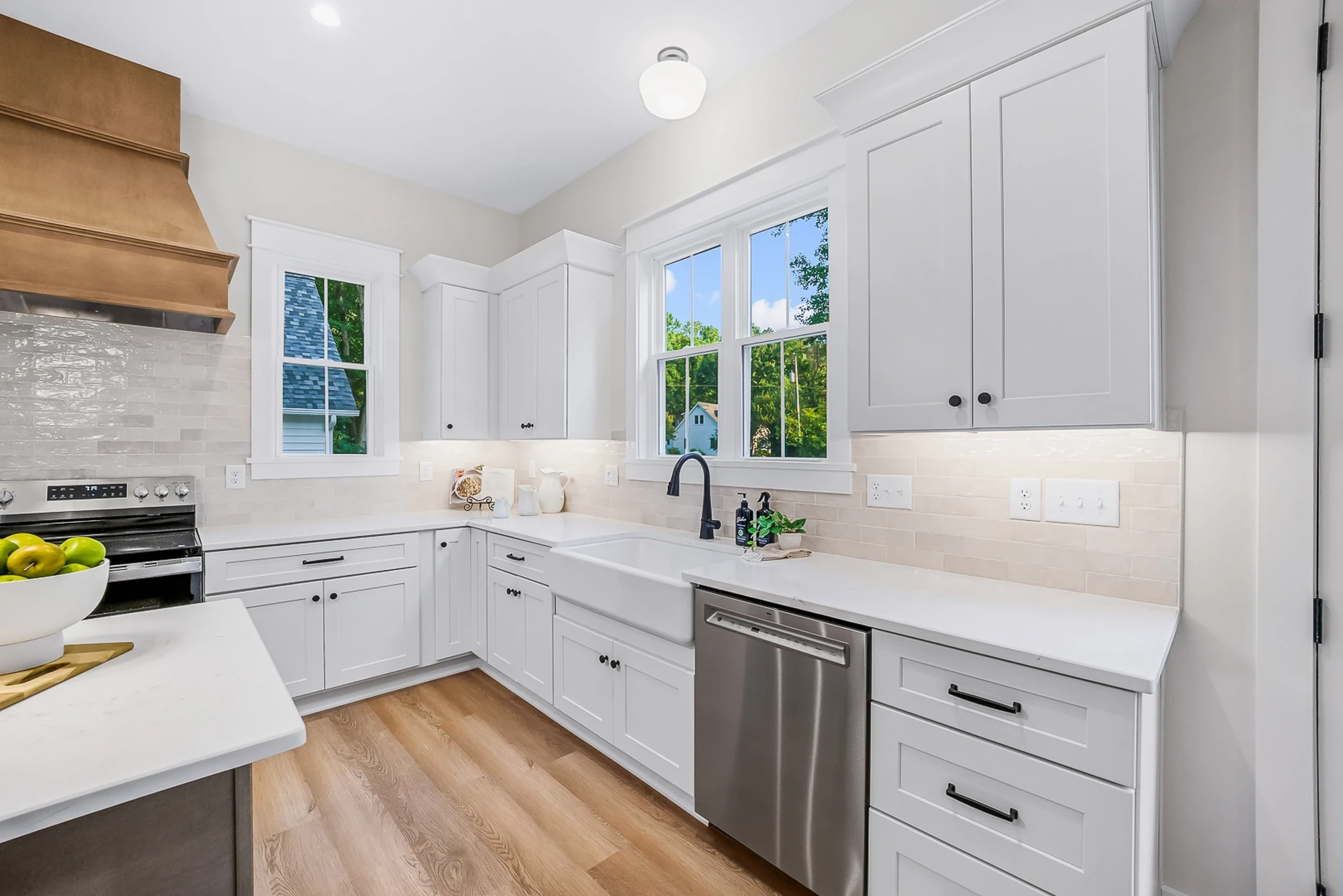 Custom kitchen — farmhouse sink and white shaker cabinetry