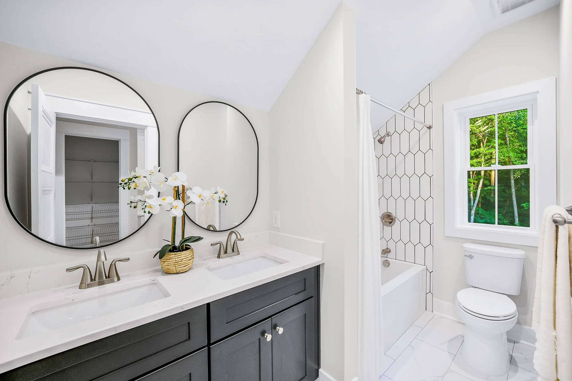 Bathroom with double vanity and round mirrors
