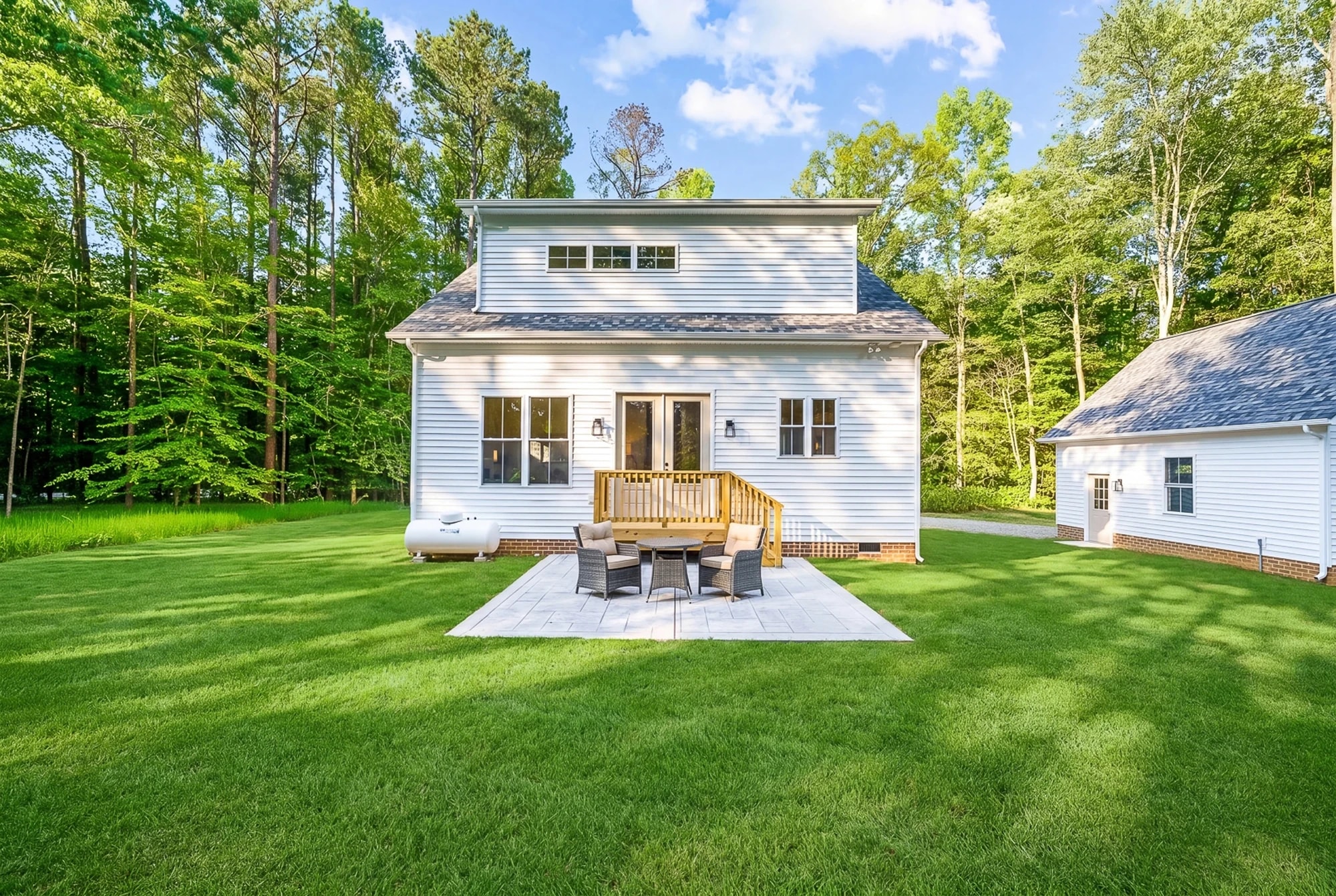 Custom farmhouse build — rear patio with outdoor dining