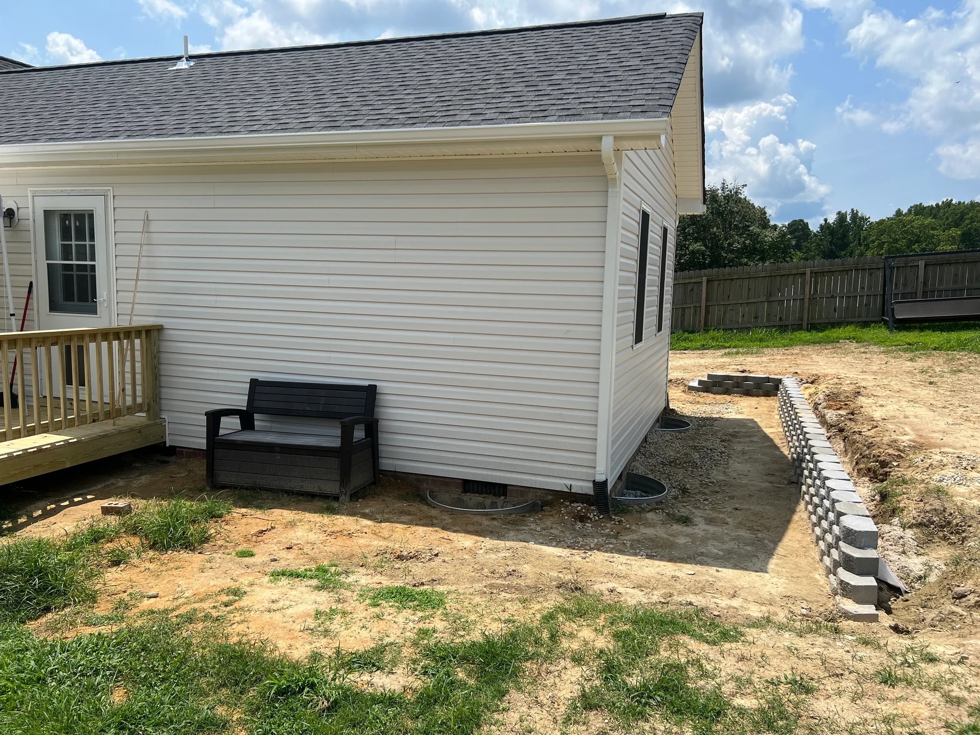 Home addition — rear corner and retaining wall